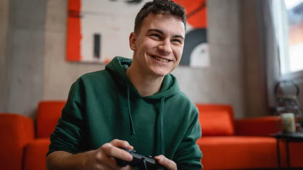 stock image One teenager caucasian male young male play console video game at home