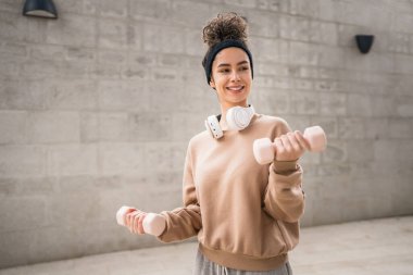 Yetişkin Kafkasyalı kadın, günlük antrenmanında halterli ağırlık kullanan kadın sporcu. Gerçek insan sağlığı ve zindelik konsepti uzay fotokopisi.