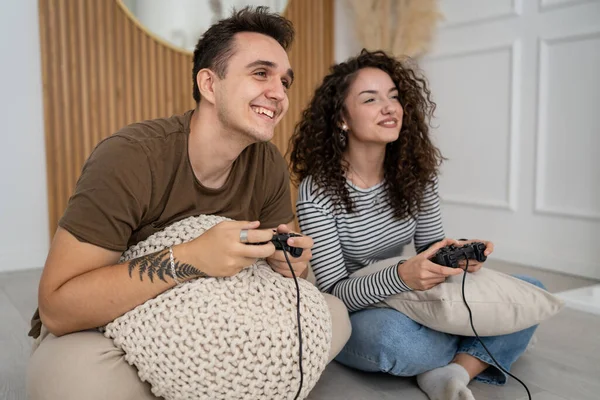 stock image Two people couple man and woman boyfriend and girlfriend husband and wife or friends play console video games hold joystick controller happy smile emotional gesture reaction family leisure copy space