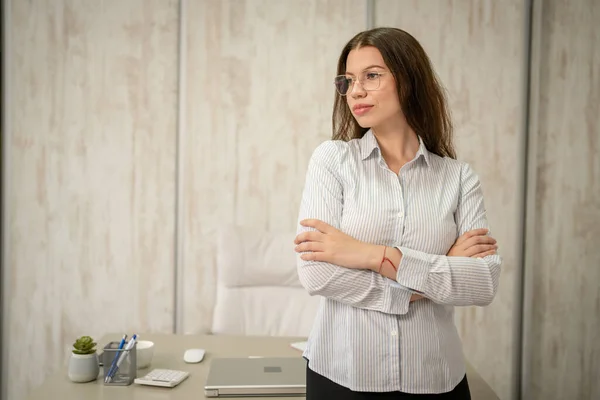 stock image One woman young adult caucasian female stand at her office desk at work front view waist up copy space wear shirt looking confident with eyeglasses