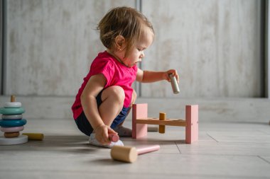 one child small caucasian girl little toddler playing with educational toys at home childhood and growing up early development concept copy space side view