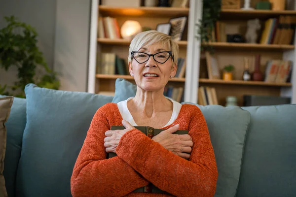 stock image One woman mature senior caucasian female pensioner modern grandmother with short hair read book at home wear eyeglasses real person copy space