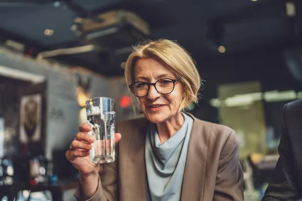 Tranquil Setting Cafe Introspective Woman Holds Glass Water Deep Thought — Stock Photo, Image