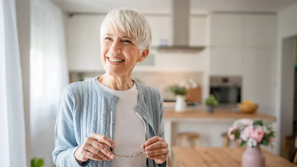 stock image Close up portrait of one senior woman with short hair happy smile positive emotion copy space standing at home indoor gray white hair