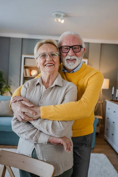 Portrait of senior husband and wife happy caucasian man and woman old couple at home