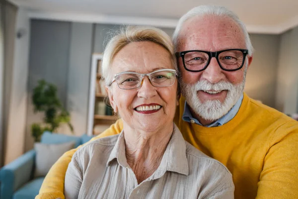 Portrait of senior husband and wife happy caucasian man and woman old couple at home