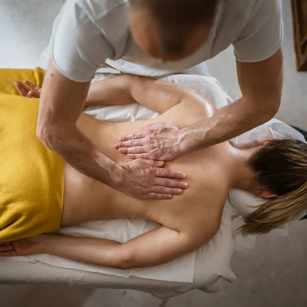 stock image Unknown woman lying while have back massage by male caucasian therapist at beauty spa treatments salon healthcare relaxation concept copy space top view