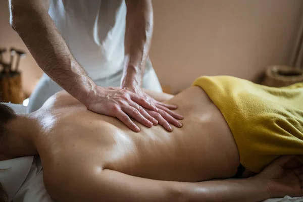 stock image Unknown woman lying while have back massage by male caucasian therapist at beauty spa treatments salon healthcare relaxation concept copy space