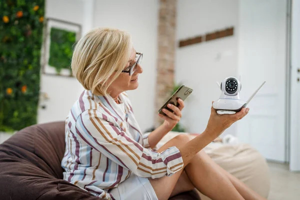 One Mature Caucasian Woman Holding Home Modern Security Surveillance Camera — Stock Photo, Image
