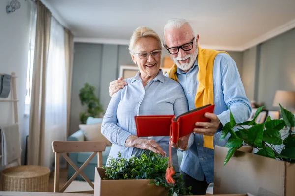 stock image Senior couple man and woman husband wife looking family photos album caucasian old male and female grandfather and grandmother happy smile at home with old pictures real people copy space