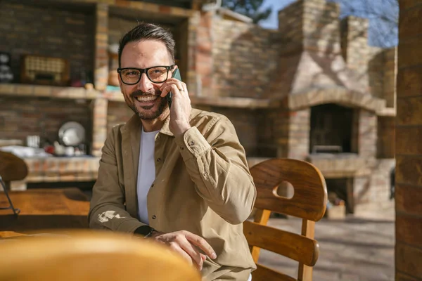 晴れた日にはひげと眼鏡を屋外で一人の男大人の白人男性幸せな笑顔は コールトークコピースペースを作るために携帯電話を使用リアル人々 — ストック写真