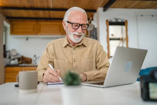 stock image One senior caucasian man grandfather with beard and eyeglasses work on laptop use computer at home online happy smile success