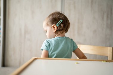 One girl small caucasian toddler playing at home in summer day