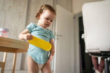 One girl small caucasian toddler playing at home in summer day