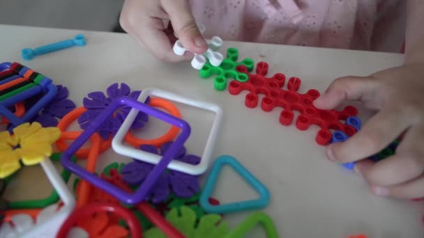 Close Hands Unknown Child Play Interlocking Plastic Toys — Stock Video