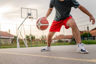 Kafkas asıllı bir genç adam basketbol sahasında duruyor. Akşamları elinde top, fotokopi çekmeye hazır. Gerçek insan.