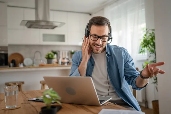 Kafkasyalı Bir Erkek Evinde Kulaklıkla Bilgisayar Başında Müşteri Destek Güler — Stok fotoğraf