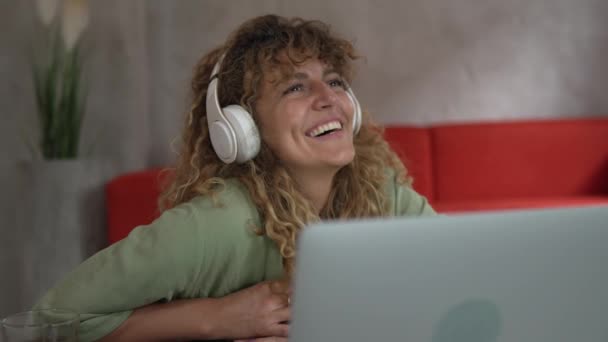 Μια Καυκάσια Γυναίκα Σγουρά Μαλλιά Κάθονται Στο Σπίτι Χρησιμοποιούν Ψηφιακή — Αρχείο Βίντεο