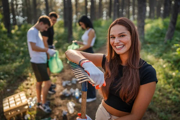 白人女性ティーンエイジャー活動家ボランティアの肖像画は 日当たりの良い日の環境ケアエコロジーキャンペーンコンセプトで自然をきれいにする森林から廃棄物のプラスチックボトル紙を拾う際に — ストック写真
