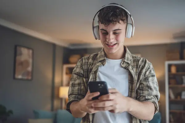 Portrait Teenage Boy Stand Home Use Headphones Ans Smartphone Play — Stock Photo, Image
