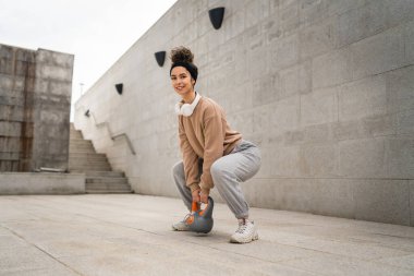 Kafkasyalı genç bir bayan sporcu gün içinde dışarıda Rus çanı Girya Kettlebell ağırlık egzersizi ile antrenman yapıyor.