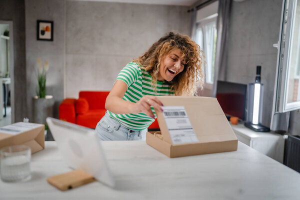 one happy woman open mail cardboard package box present at home