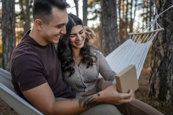 两个年轻人坐在自然森林公园里庆祝爱情真人真事人抄袭空间的时候 高加索男人和女人的男女朋友或丈夫和妻子送给礼品盒 — 图库照片