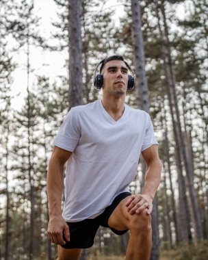 Bir erkek beyaz erkek sporcu ormanda doğada koşuyor ya da sonbaharda ya da yaz günlerinde spor yapıyor spor yapıyor spor yapıyor sağlıklı yaşam tarzı kavramı gerçek insanlar mekanı kopyalıyor.