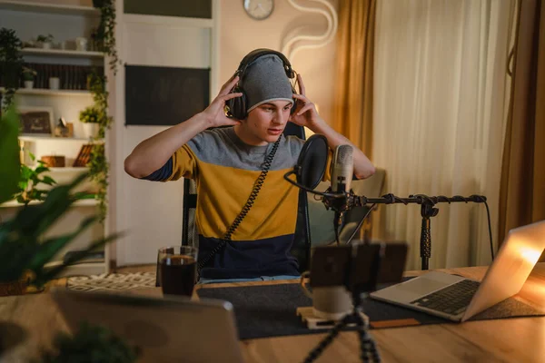 stock image One man caucasian male blogger or vlogger gesticulating while streaming video podcast in broadcasting studio use microphone and headphones famous influencer shooting video for channel podcast