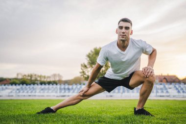 Bir erkek beyaz erkek atlet stadyum pistinde koşuyor ya da sonbahar ya da yaz sporlarında spor yapıyor spor yapıyor spor yapıyor sağlıklı yaşam tarzı kavramını gerçek insanlar taklit ediyor.