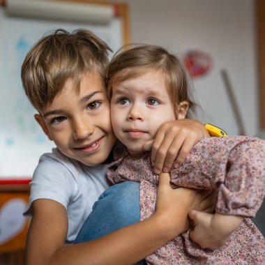 siblings portrait caucasian boy and girl brother and sister at home