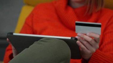 Close up on hand of unknown woman hold credit card shopping online