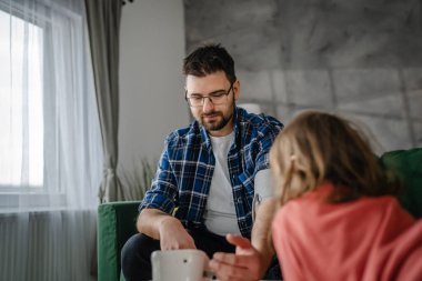 Man caucasian male sit at the table at home check measure blood pressure real person health care concept