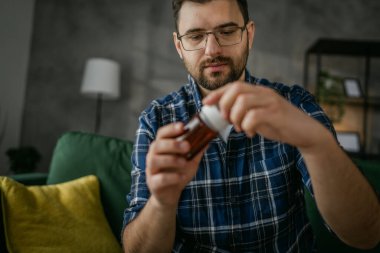 One man take medicine drugs bottle pills or nutrition supplement