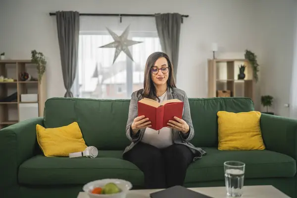 one pregnant woman read book at home