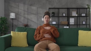 Yetişkin bir kadın Kafkasyalı kadın meditasyon yapıyor milenyum meditasyonu evde gözleri kapalı farkındalık yogası yapıyor gerçek insanlar kişisel bakım kavramını kopyalıyor.
