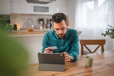 İnternet üzerinden alışveriş yapan yetişkin bir adam internet üzerinden kredi kartı kullanıyor e-bankacılık internet üzerinden e-ticaret yapıyor