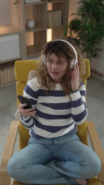 One Caucasian Woman Adult Female Headphones Use Mobile Phone Home — Stock Video