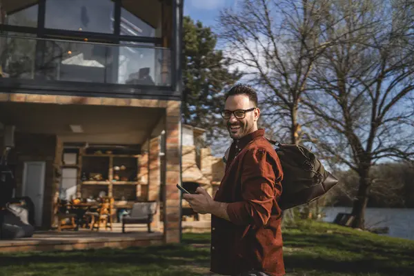 Portrait of one man happy caucasian male with travel bag at his house