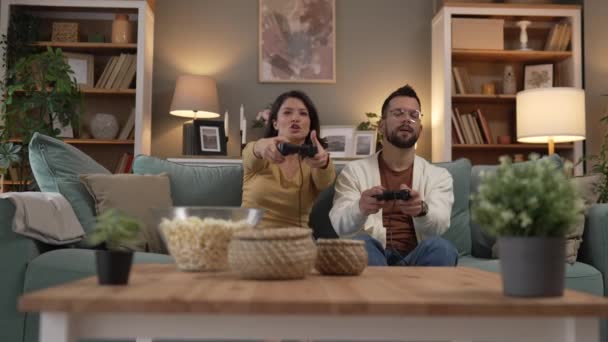 成年男女夫妇在家里玩电玩电玩 手握操纵杆控制器 享受休闲快乐和友谊的概念 — 图库视频影像