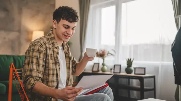 Young Man Hold Paper Read Good News Letter Sit Home — Stock Photo, Image