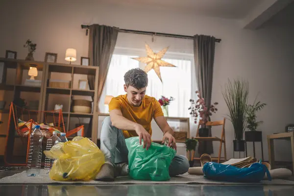 Egy Férfi Fiatal Felnőtt Újrahasznosítás Otthon Rendezni Hulladék Műanyag Papír — Stock Fotó