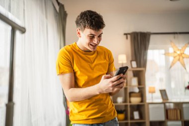 Kafkasyalı bir genç çocuk cep telefonu akıllı telefon mesajı kullanıyor.