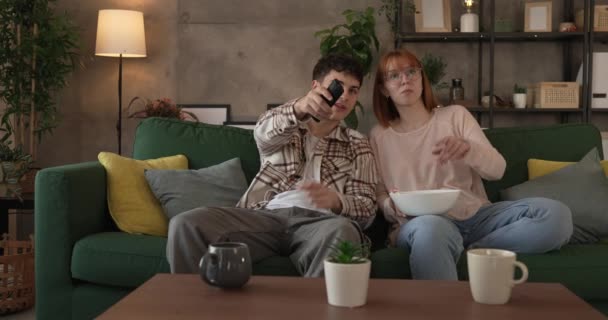 Ζευγάρι Καυκάσιος Άνδρας Και Γυναίκα Κάθονται Στο Σπίτι Στον Καναπέ — Αρχείο Βίντεο