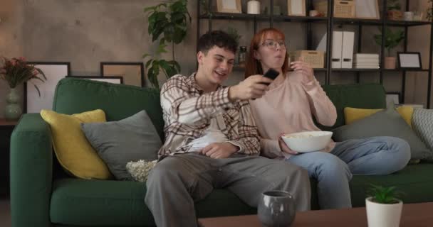Ζευγάρι Καυκάσιος Άνδρας Και Γυναίκα Κάθονται Στο Σπίτι Στον Καναπέ — Αρχείο Βίντεο