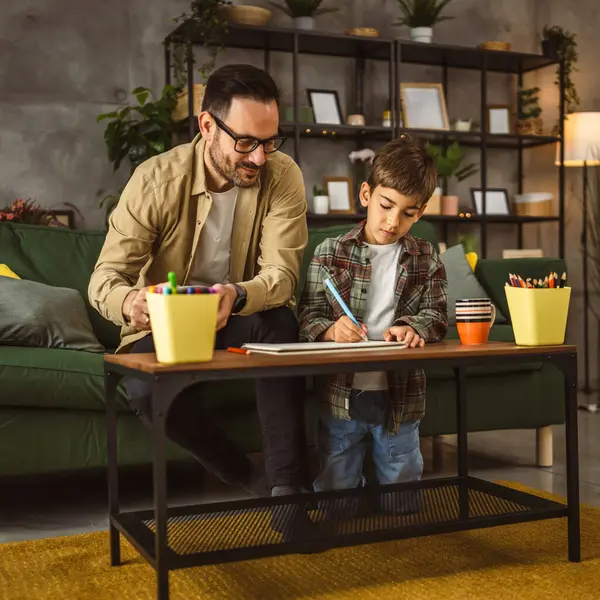 stock image Father with eyeglasses and son caucasian draw and paint together at home leisure activity