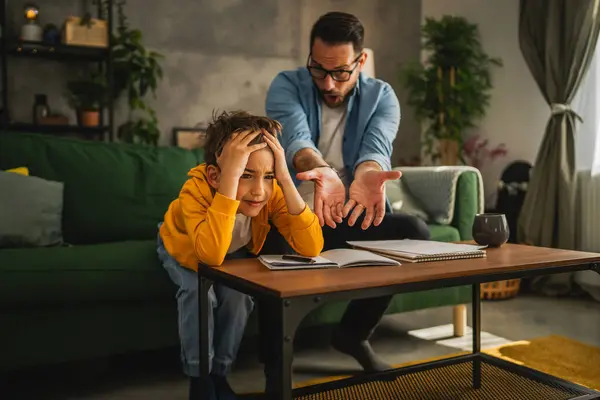 Exhausted Father Help Son Finish His Homework While Son Have Royalty Free Stock Photos