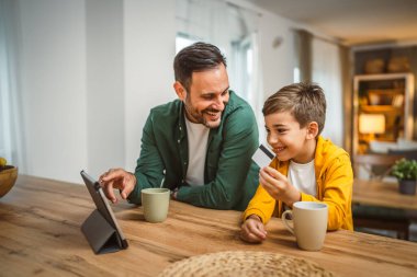 Baba ve oğlu Kafkasyalı online alışveriş yapıyor. Evdeki kredi kartıyla.