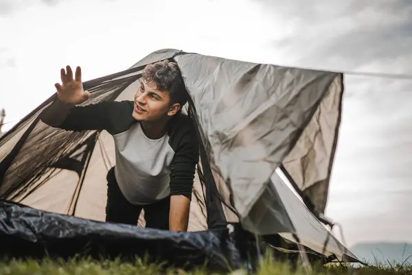 stock image Yong boy camp and wake up in the tent ready for new day