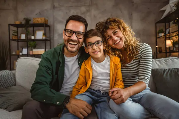 stock image Portrait of mother and father with son sit on sofa in the living room